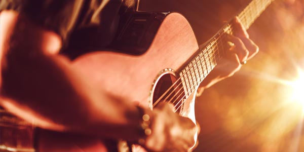A Lead guitarist playing his rocking ryhthm on stage.