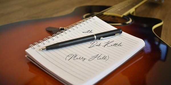 Image Shows a notebook which places on the guitar.
