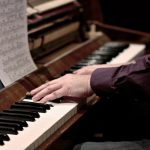 A Human Hand Playing Piano To Relieve Stress.